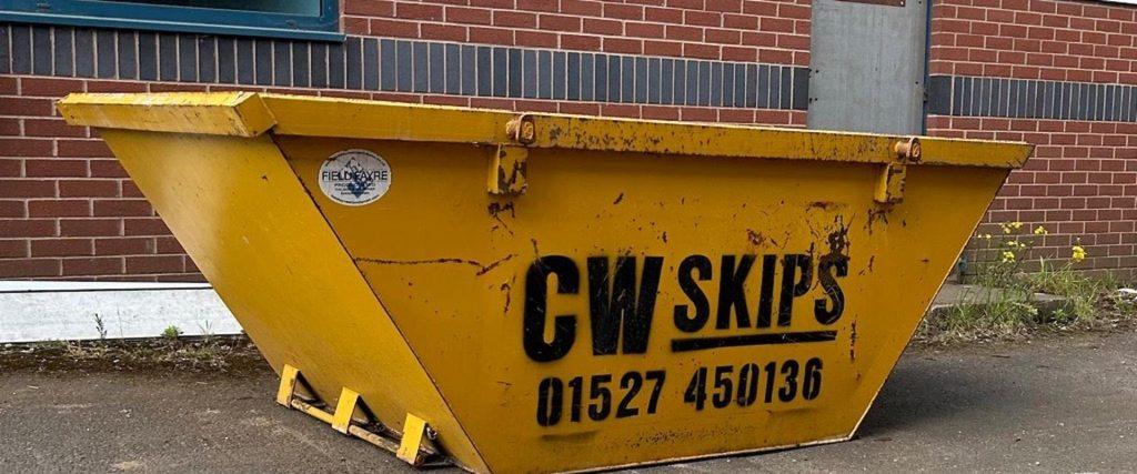 Yellow skip with logo on the side